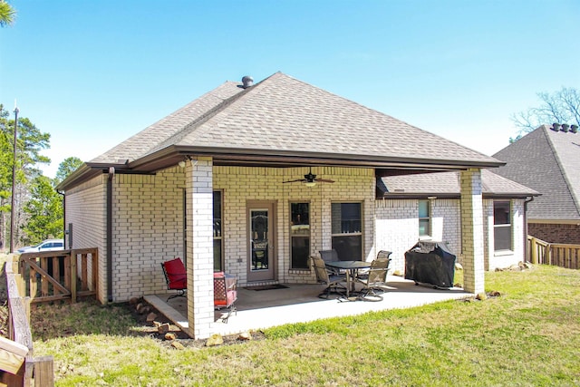 back of house featuring a patio, a ceiling fan, fence, a shingled roof, and a lawn