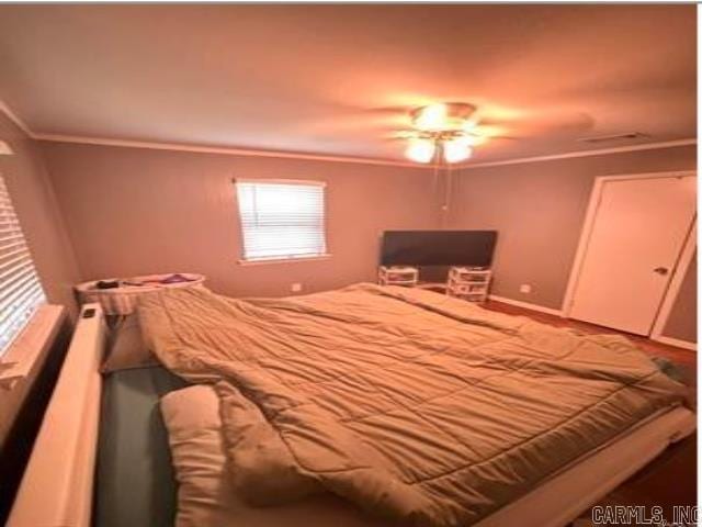 bedroom with baseboards and ornamental molding