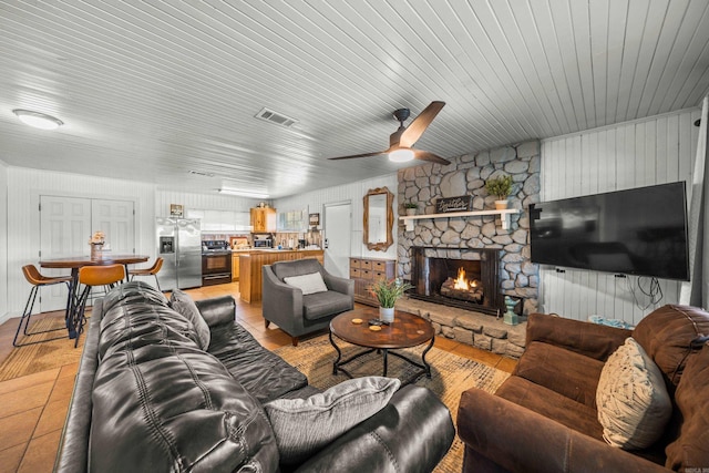 205 Ledgerock, Hot Springs, AR 71913 - living area featuring light tile patterned floors, visible vents, a stone fireplace, and a ceiling fan