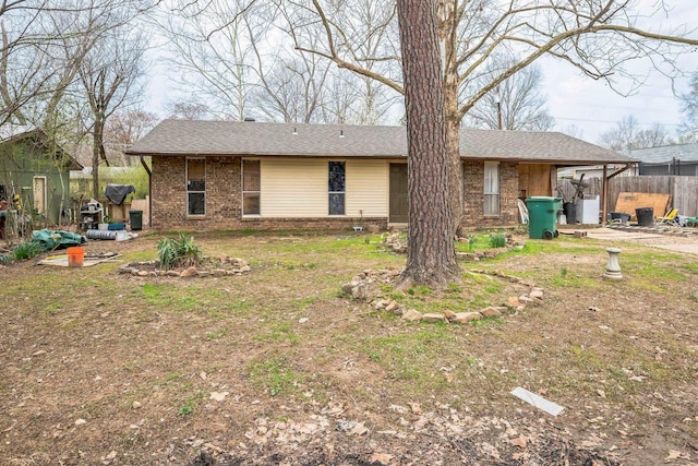 view of front facade with brick siding and fence