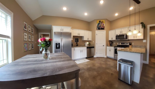 kitchen featuring light stone countertops, appliances with stainless steel finishes, finished concrete floors, and white cabinetry