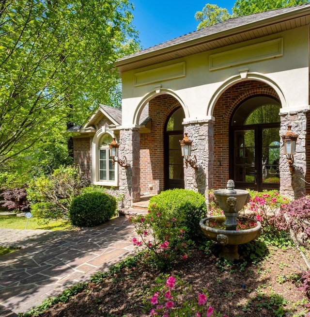 33 Greathouse Bend Dr, Little Rock, AR 72207 - doorway to property with stucco siding and brick siding