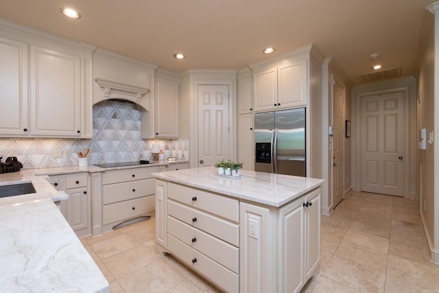33 Greathouse Bend Dr, Little Rock, AR 72207 - kitchen featuring built in fridge, backsplash, white cabinetry, and light stone counters