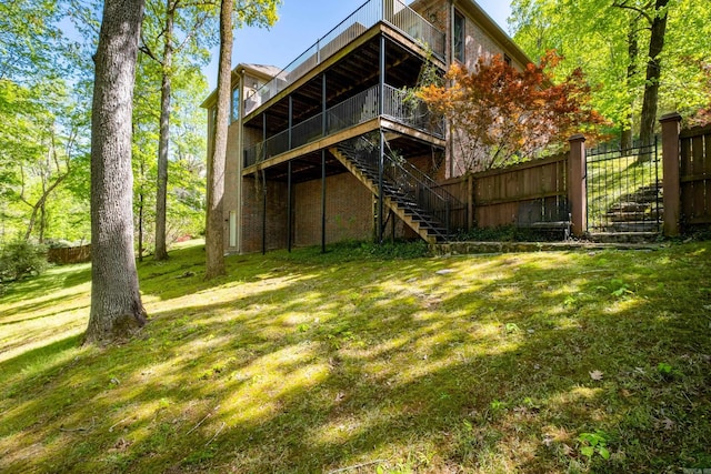 33 Greathouse Bend Dr, Little Rock, AR 72207 - rear view of property featuring a lawn, a wooden deck, stairway, and fence