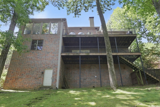 33 Greathouse Bend Dr, Little Rock, AR 72207 - back of house featuring brick siding, a yard, a wooden deck, and stairway