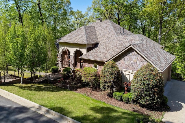 33 Greathouse Bend Dr, Little Rock, AR 72207 - view of front of house featuring stone siding, a shingled roof, and a front lawn