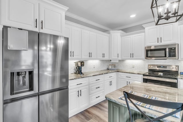 kitchen with stainless steel appliances, decorative backsplash, crown molding, and white cabinetry