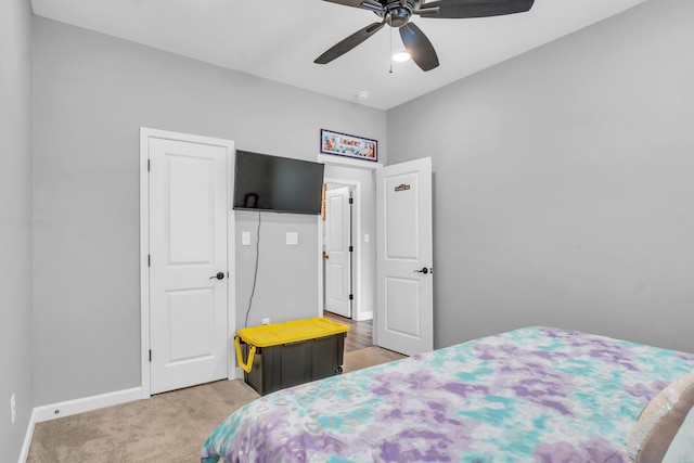 bedroom with baseboards, light colored carpet, and ceiling fan