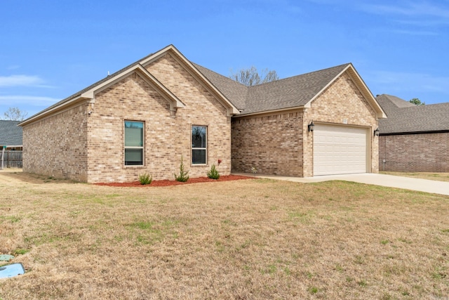 single story home featuring driveway, a front lawn, roof with shingles, a garage, and brick siding
