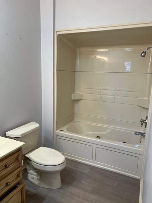 4000 Ridgepointe Cv, Jonesboro, AR 72404 - bathroom with vanity, toilet, wood finished floors, and washtub / shower combination
