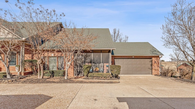 4000 Ridgepointe Cv, Jonesboro, AR 72404 - view of front of home with a garage, brick siding, driveway, and a shingled roof