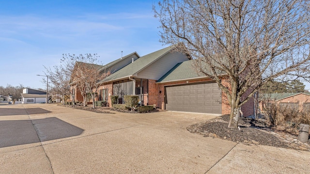 4000 Ridgepointe Cv, Jonesboro, AR 72404 - view of front of home with an attached garage, brick siding, driveway, and a shingled roof
