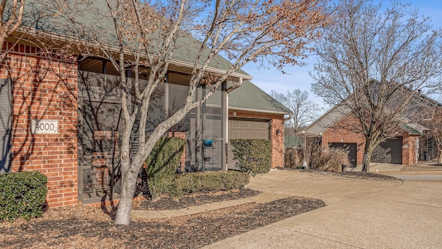 4000 Ridgepointe Cv, Jonesboro, AR 72404 - exterior space featuring brick siding, driveway, and a shingled roof