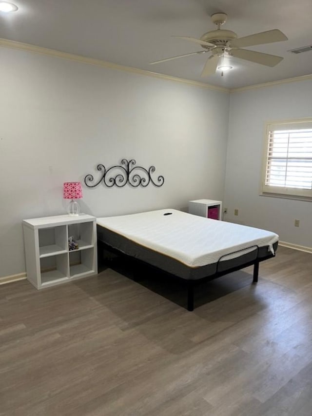 4000 Ridgepointe Cv, Jonesboro, AR 72404 - unfurnished bedroom with visible vents, crown molding, baseboards, and wood finished floors