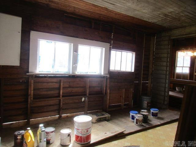 410 E Magnolia St, Rison, AR 71665 - misc room featuring log walls, plenty of natural light, and wooden ceiling