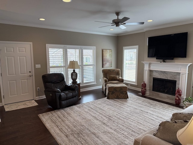 living room featuring a wealth of natural light, a ceiling fan, and crown molding