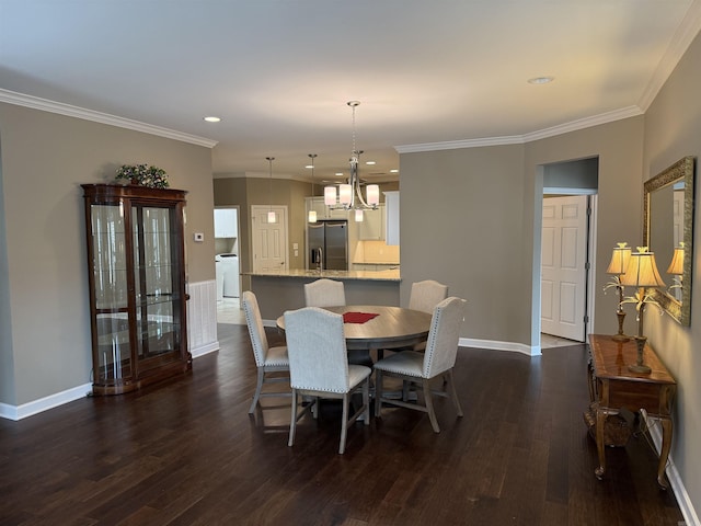 dining space with baseboards, crown molding, an inviting chandelier, and dark wood-style flooring