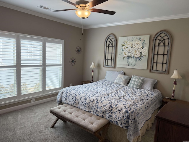 carpeted bedroom featuring visible vents, baseboards, ceiling fan, and crown molding