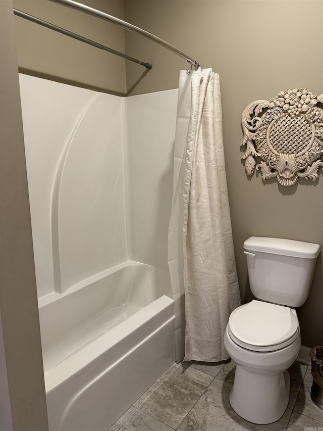 bathroom featuring toilet and shower / bath combo