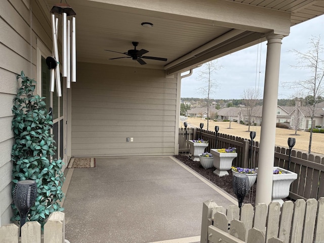 view of patio / terrace with ceiling fan and fence