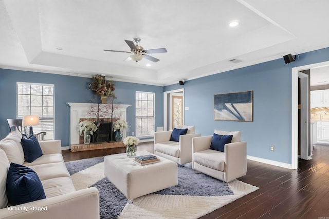 7704 Toltec Dr, North Little Rock, AR 72116 - living room with a tray ceiling, a ceiling fan, and dark wood-style floors
