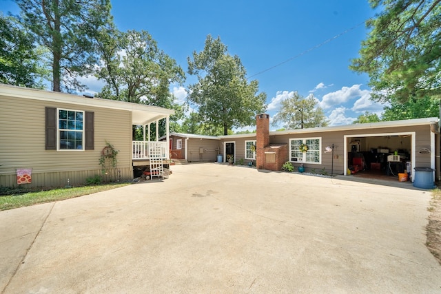 back of house featuring concrete driveway and a garage