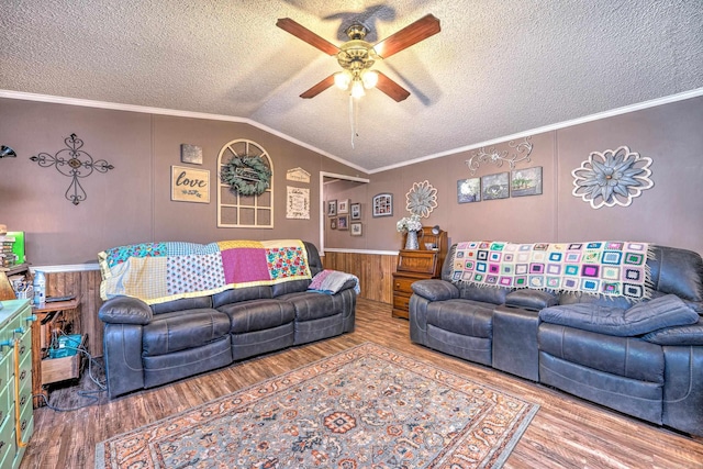 living area with lofted ceiling, a ceiling fan, and ornamental molding