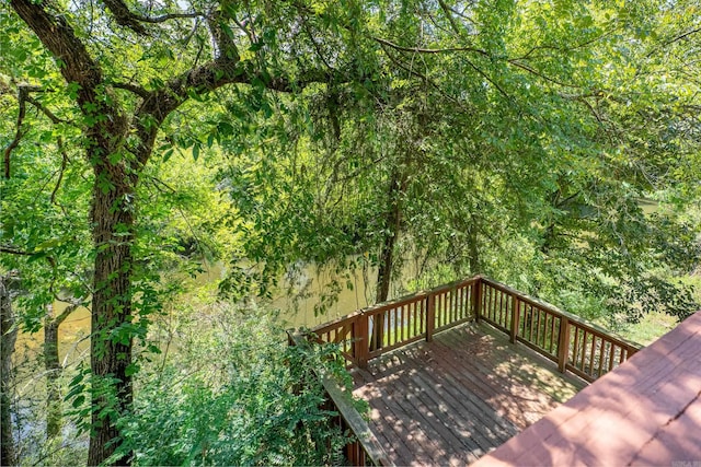 wooden deck featuring a view of trees