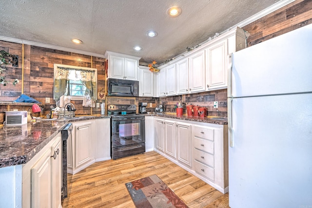 kitchen with light wood finished floors, black appliances, white cabinets, a textured ceiling, and tasteful backsplash