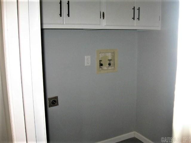 laundry room featuring cabinet space, hookup for an electric dryer, baseboards, and washer hookup