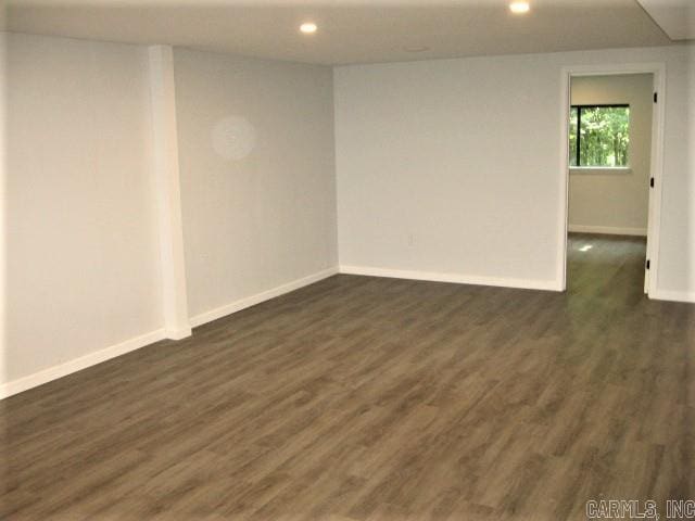unfurnished room with recessed lighting, baseboards, and dark wood-style flooring