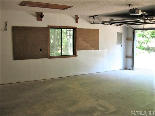 garage with electric panel and a garage door opener