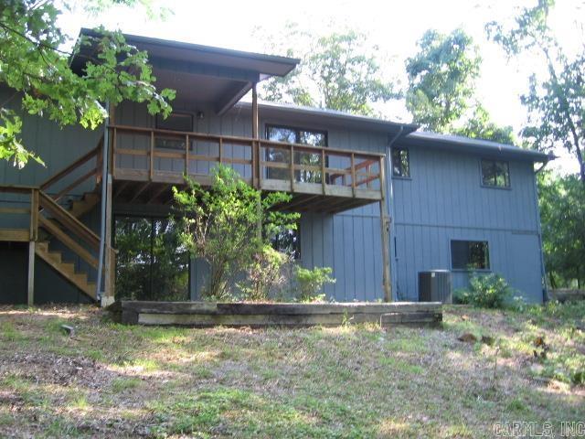 back of property featuring central AC and stairs