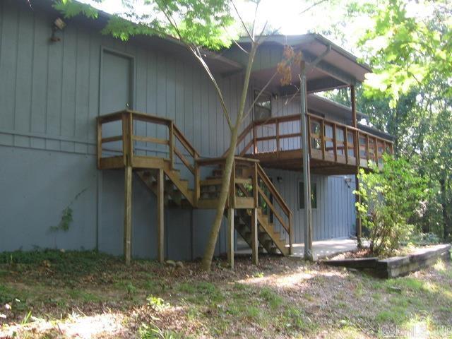 exterior space featuring stairs and a wooden deck