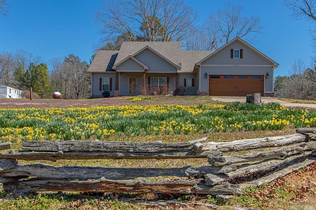 view of front of property featuring an attached garage and a shingled roof