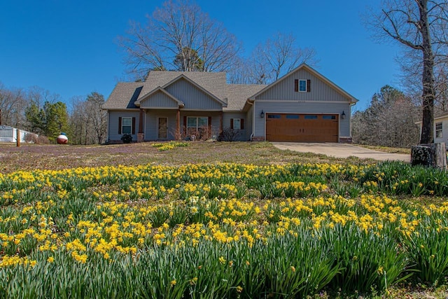 craftsman house with concrete driveway and a garage