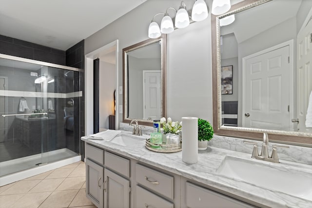 full bath with a sink, double vanity, and a shower stall