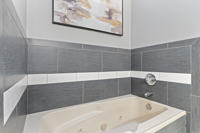 full bath with a tub with jets