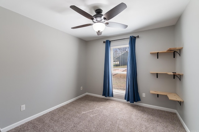unfurnished room with baseboards, ceiling fan, and carpet flooring