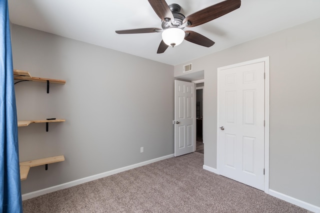 unfurnished bedroom with visible vents, baseboards, ceiling fan, and carpet flooring