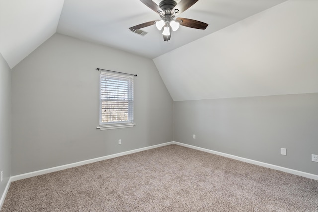 bonus room with lofted ceiling, carpet flooring, a ceiling fan, and baseboards