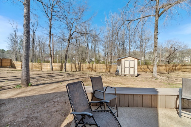 view of yard with a storage shed, an outdoor structure, a fenced backyard, and a patio