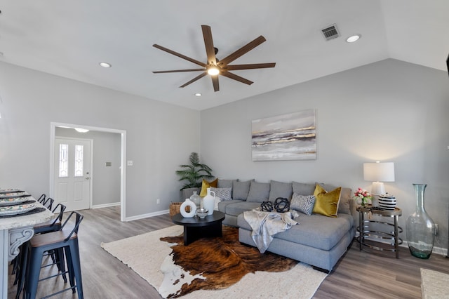 living room featuring recessed lighting, lofted ceiling, wood finished floors, and a ceiling fan