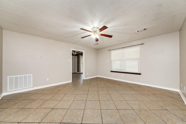 spare room featuring visible vents, baseboards, and a ceiling fan