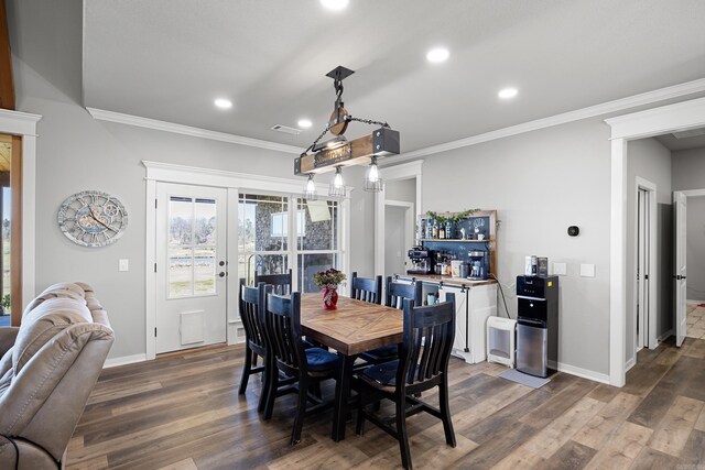dining space featuring french doors, wood finished floors, baseboards, and ornamental molding