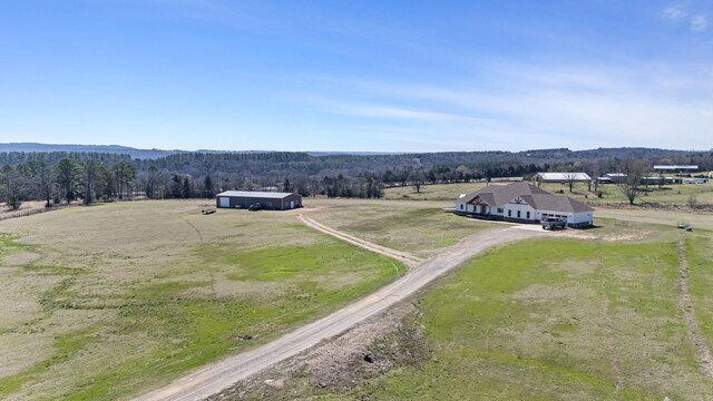 aerial view featuring a rural view and a wooded view
