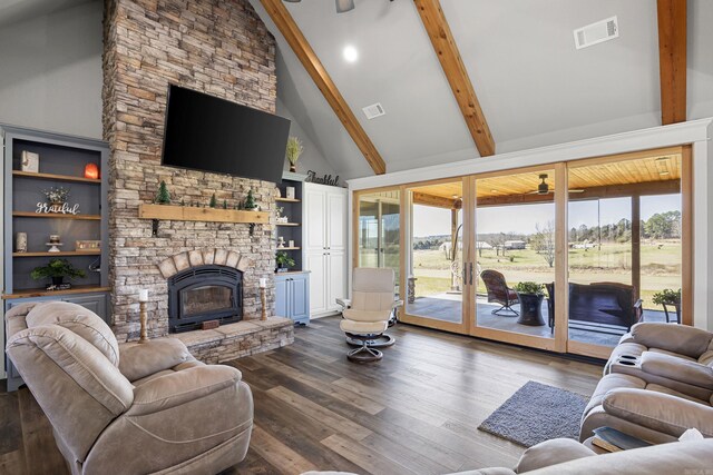 living room with visible vents, beamed ceiling, a stone fireplace, dark wood-style floors, and high vaulted ceiling