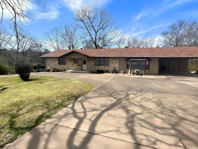 ranch-style home with a carport, driveway, and a front yard