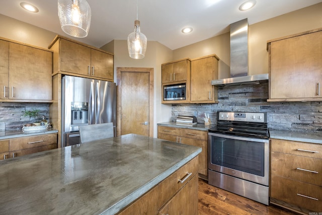 kitchen featuring wall chimney range hood, stainless steel appliances, dark wood-style flooring, and backsplash