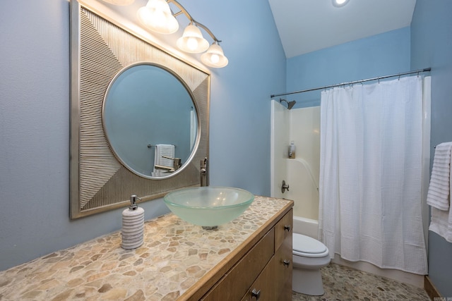 bathroom with toilet, vanity, shower / bath combo with shower curtain, and vaulted ceiling